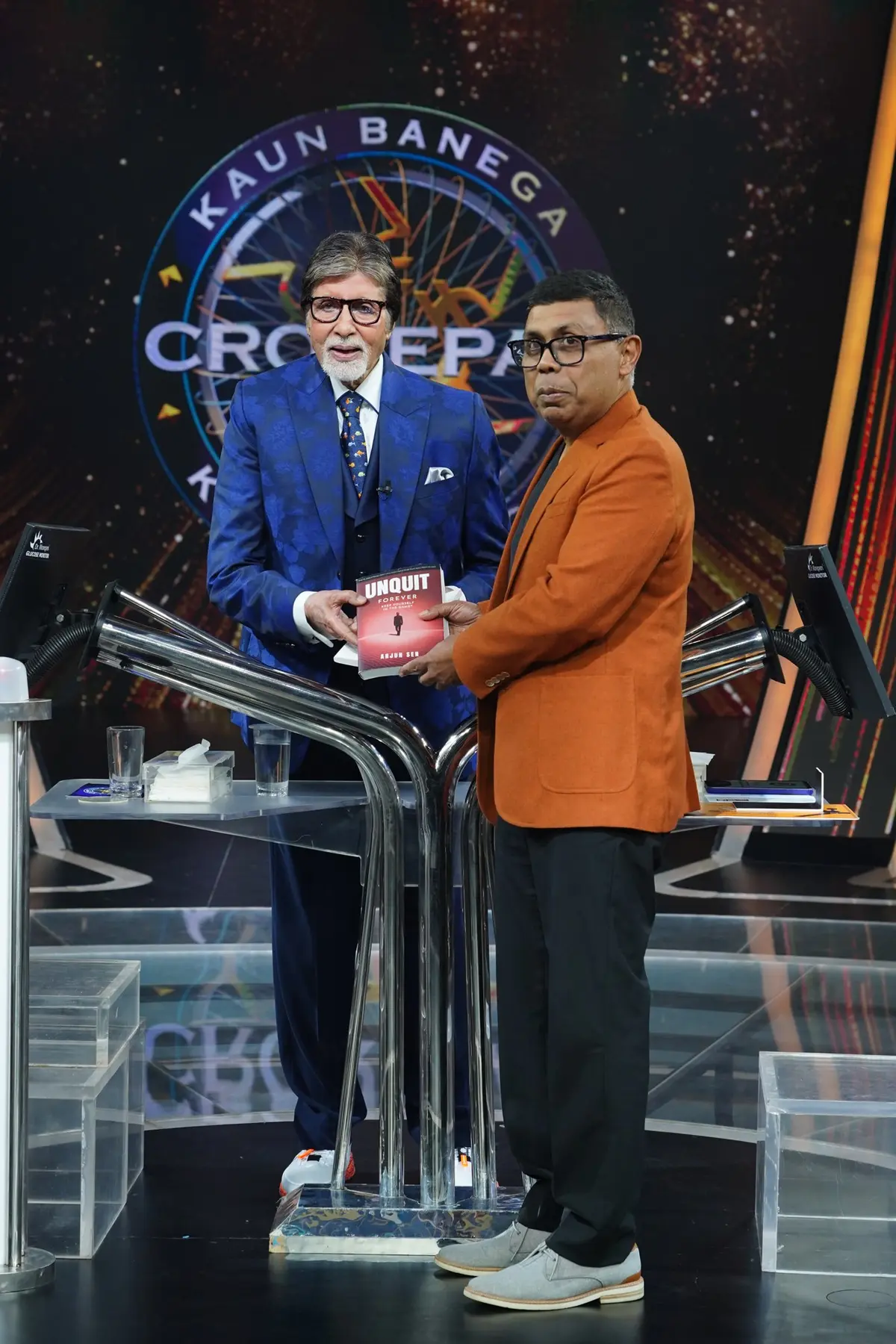 Amitabh Bachchan holding Unquit Forever beside Arjun Sen
