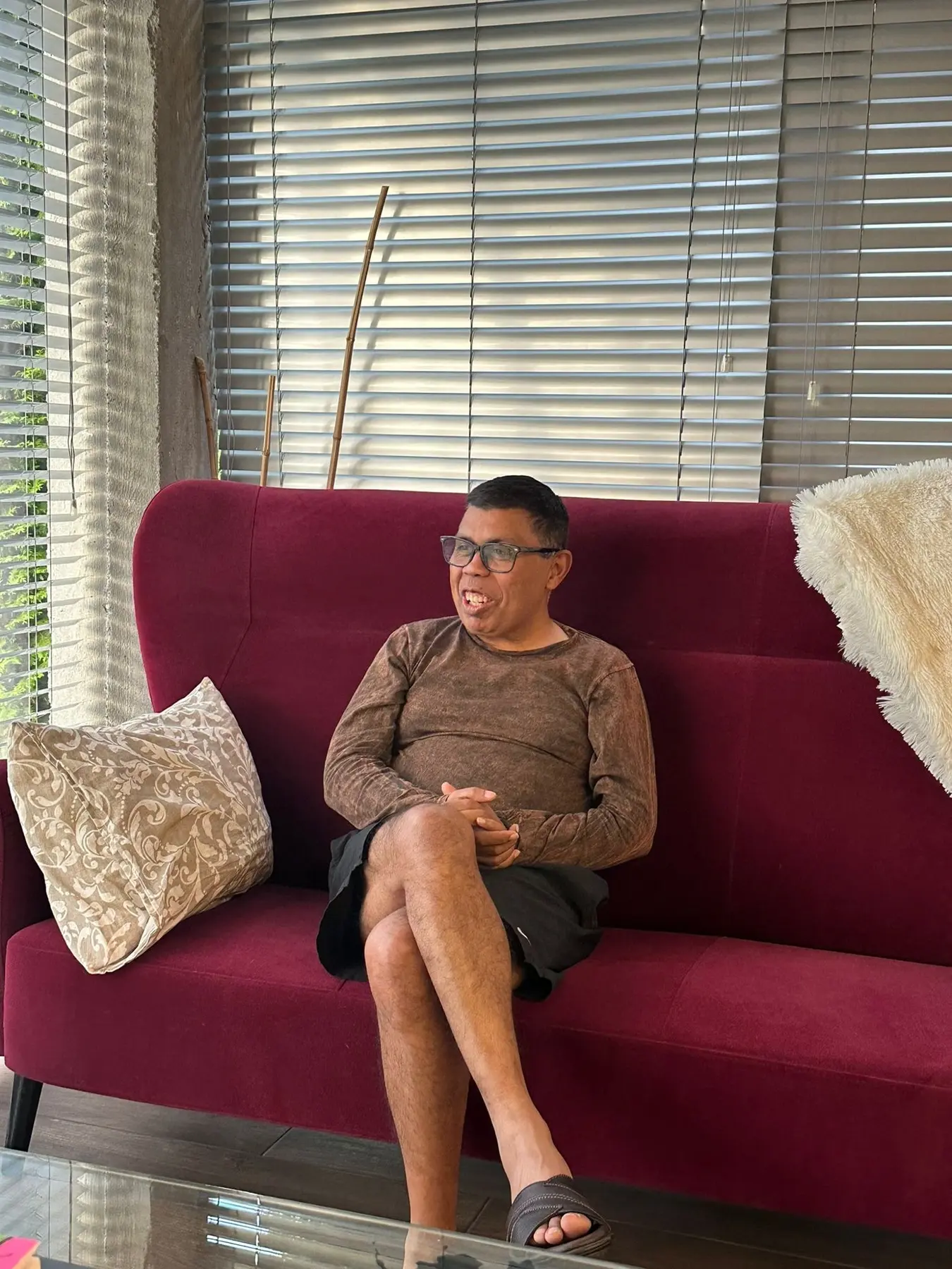 Arjun Sen laughing while seated at home
